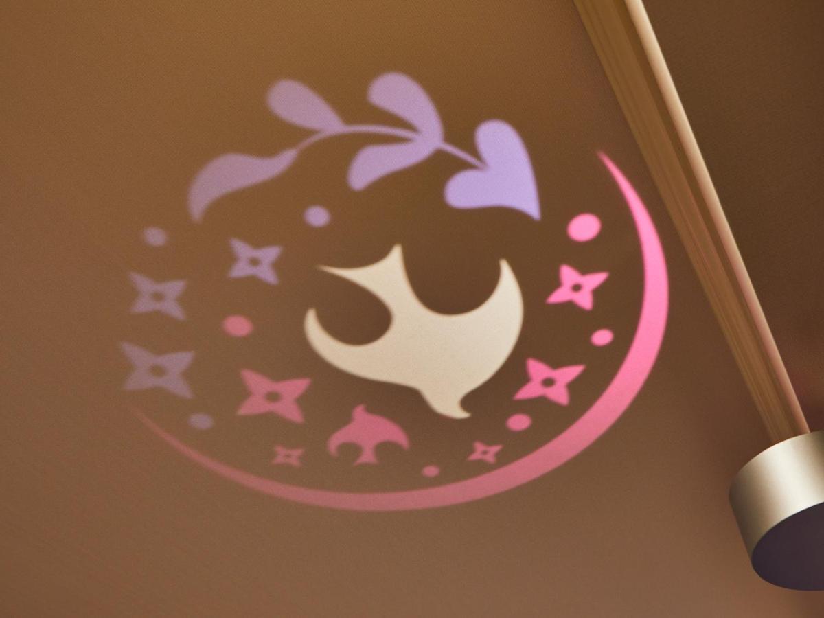 Grand Nikko Tokyo Bay Maihama Hotel Urayasu Exterior foto The image shows a projection on a surface, featuring a circular design with a mix of colors, primarily pink and purple. The design includes a white dove, which is likely a symbol of peace, surrounded by decorative elements such as leaves and small st